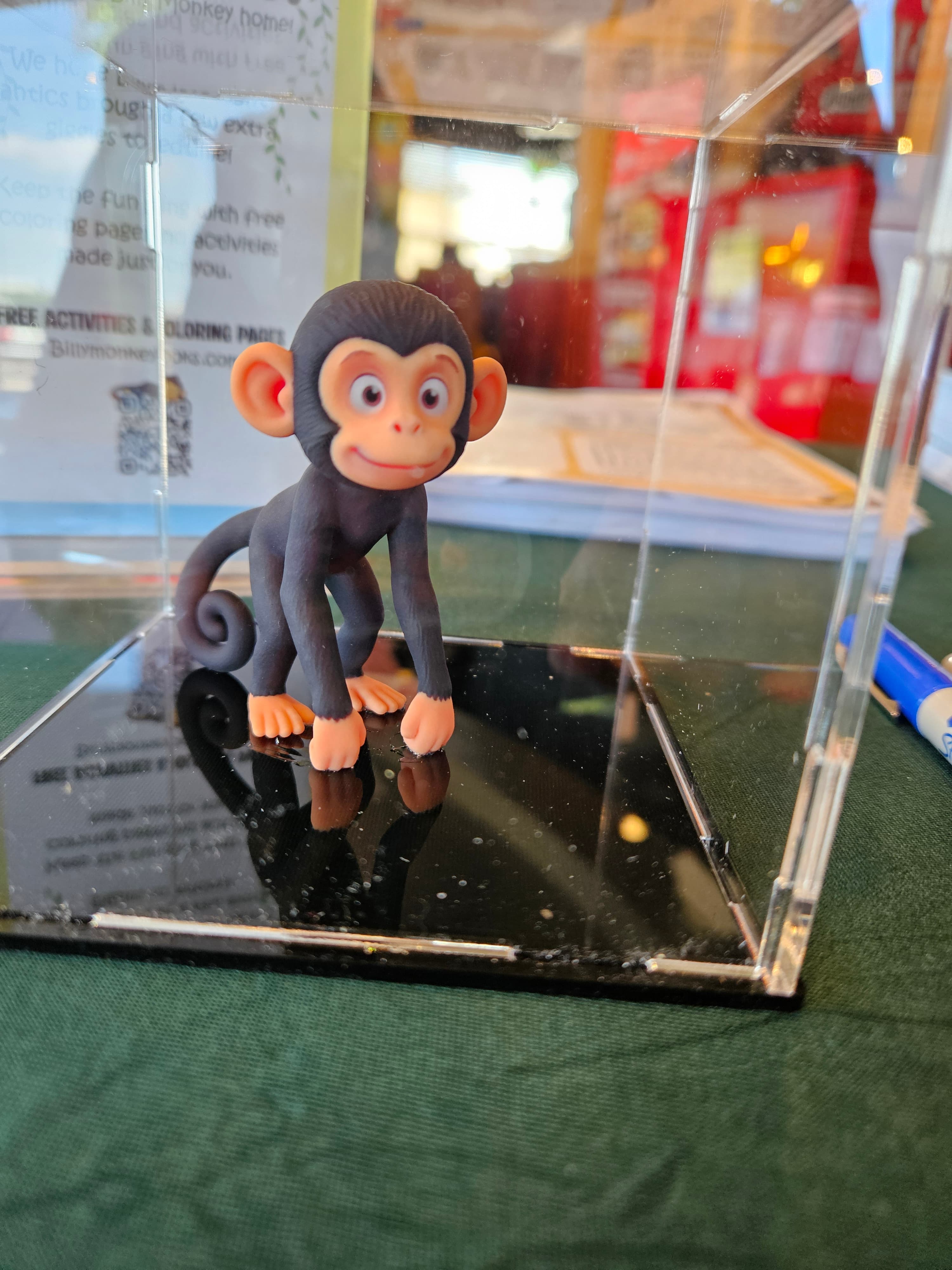 A Billy Monkey figurine on display at the signing table